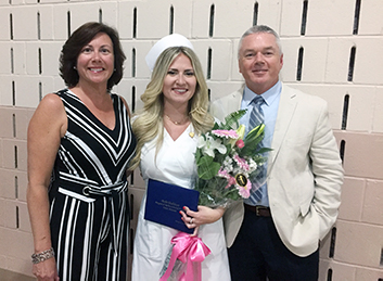 Margaret H. Rollins Student Philanthropy Award winner, Mallory Drew, shares a proud moment during the Margaret H. Rollins School of Nursing graduation with her aunt and uncle, Kerry and Clint Perkinson. 