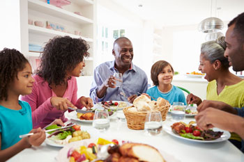 Family meals can be triggers to eat more than you need. Be mindful and enjoy the conversation instead of over-eating.