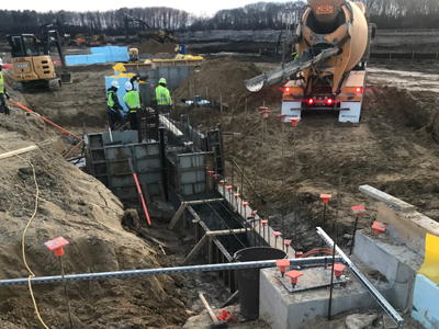 Crew pouring concrete